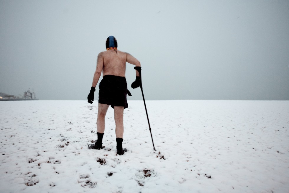 Walking over snow to get to the sea for a swim