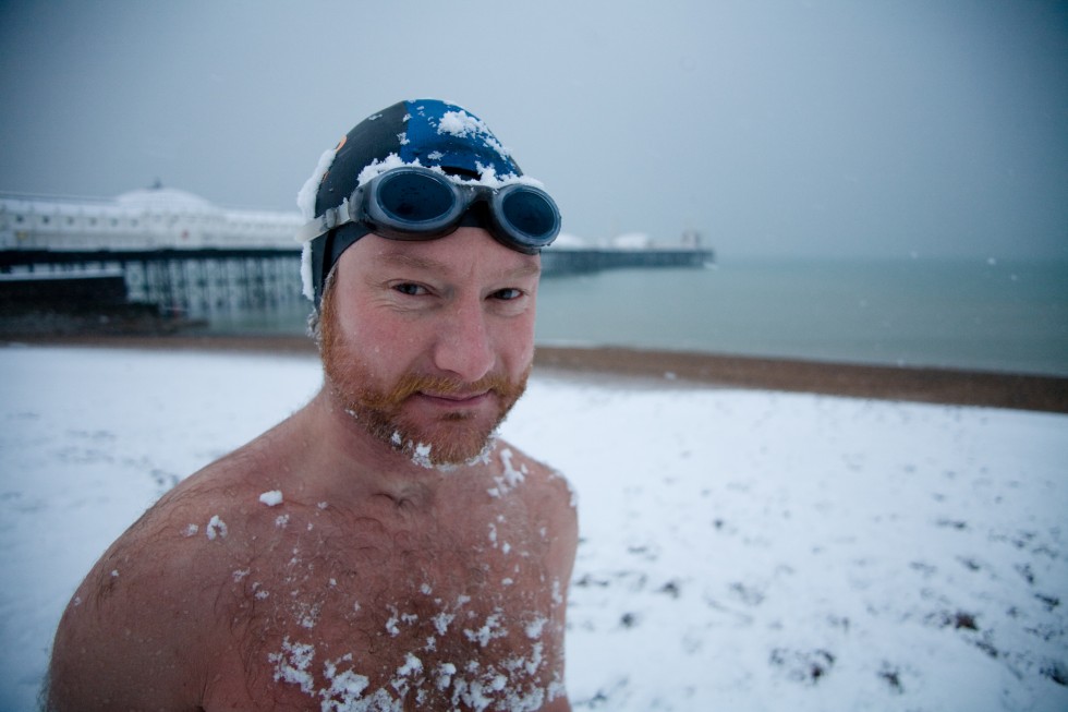 Brighton swimming club member Leo posing in on a snowy beach