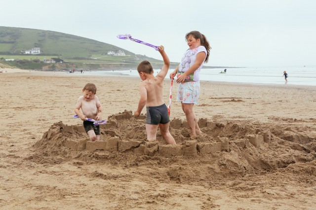 children fighting on a beach